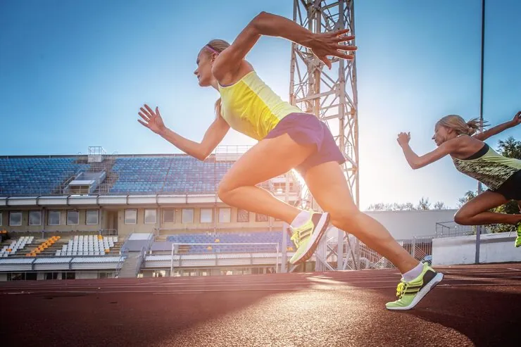 two-female-sprinter-athletes-running-treadmill-race-training-athletics-stadium_613910-19085.jpg