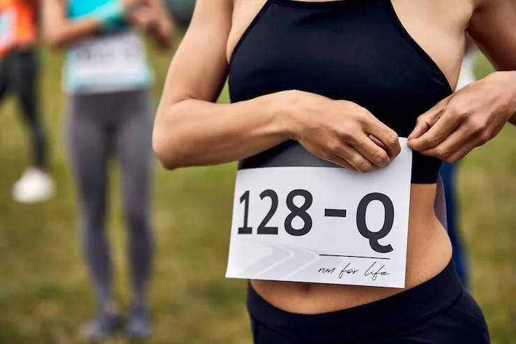 unrecognizable-athletic-woman-attaching-number-her-shirt-while-preparing-marathon-race-nature_637285-6648.jpg